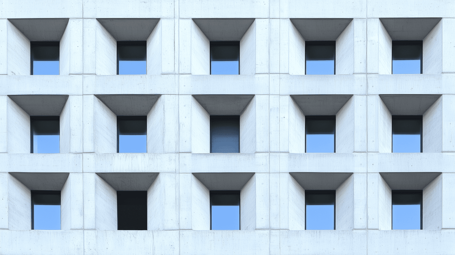 Foundry 9, a grid of deep-set windows in a restored concrete facade